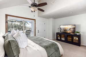 Bedroom featuring light carpet, access to outside, vaulted ceiling, and ceiling fan