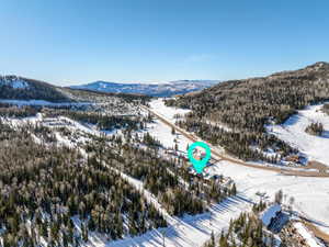 Snowy aerial view featuring a mountain view