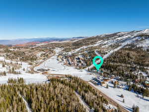 Snowy aerial view featuring a mountain view