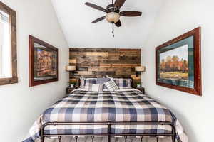 Bedroom featuring ceiling fan and lofted ceiling