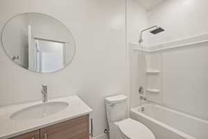 Full bathroom featuring shower / bathing tub combination, vanity, and toilet