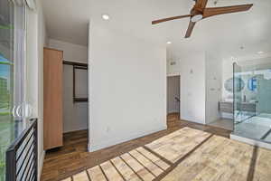 Bedroom with access to exterior, ceiling fan, a closet, and dark wood-type flooring