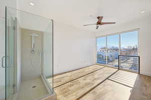 Interior space with ceiling fan and wood-type flooring