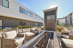 Surrounding community featuring a patio and a fire pit