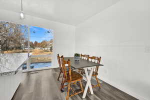 Dining area with dark wood-type flooring