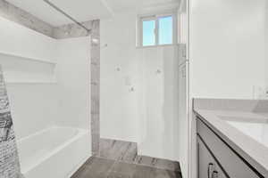 Bathroom with vanity and tiled shower / bath