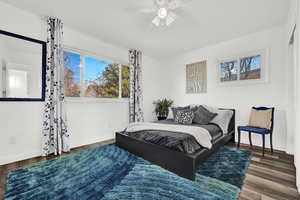 Bedroom with dark hardwood / wood-style floors and ceiling fan