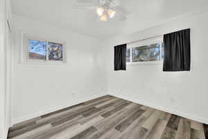 Spare room featuring ceiling fan and wood-type flooring