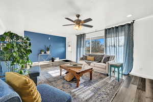 Living room featuring hardwood / wood-style flooring and ceiling fan