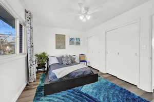 Bedroom with dark hardwood / wood-style flooring and ceiling fan