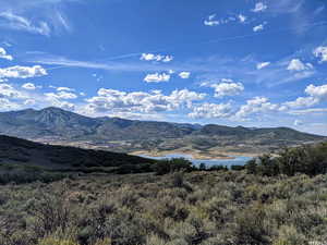 Property view of mountains featuring a water view