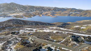 Snowy aerial view with a water and mountain view