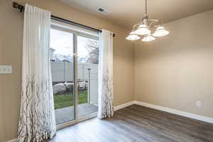 Entryway with a mountain view, hardwood / wood-style floors, and a chandelier