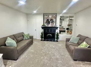 Carpeted living room with a fireplace