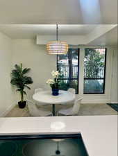 Dining room featuring tile patterned floors and a notable chandelier