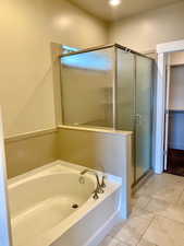 Bathroom featuring tile patterned floors and independent shower and bath