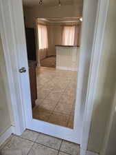 Corridor with light tile patterned floors