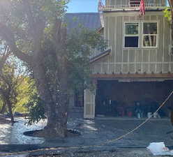 Back of house with a balcony and a garage