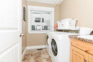 Washroom with washing machine and clothes dryer