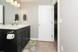 Bathroom featuring tile patterned flooring and vanity