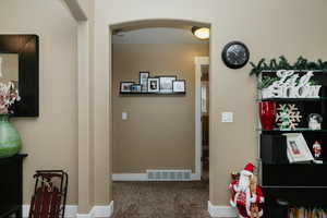 Corridor featuring carpet floors