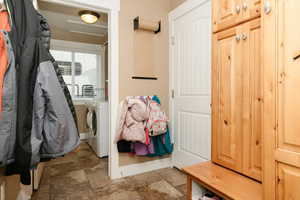 Mudroom featuring independent washer and dryer