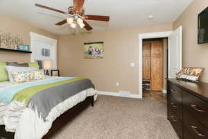 Carpeted bedroom with ceiling fan