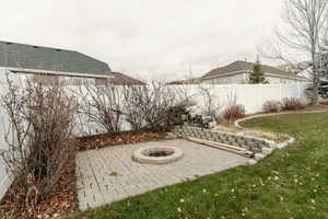 View of patio with a fire pit