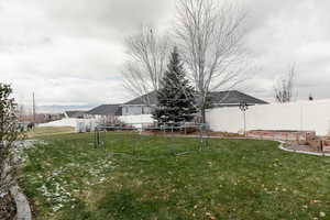 View of yard featuring a trampoline