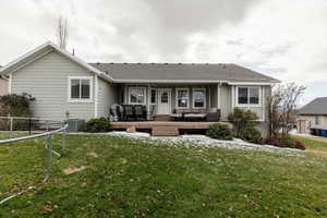 Back of property featuring a yard, an outdoor hangout area, a trampoline, and central AC unit