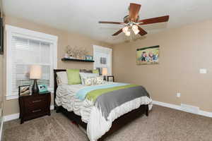 Bedroom with light colored carpet and ceiling fan