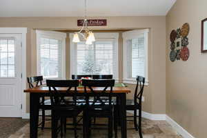 Dining area with a notable chandelier