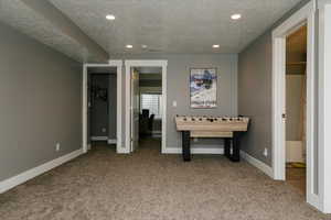 Playroom featuring carpet flooring and a textured ceiling