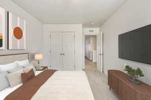 Bedroom featuring light colored carpet and a closet