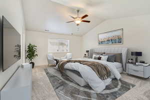 Bedroom with ceiling fan, lofted ceiling, and light carpet