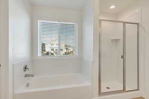 Bathroom featuring separate shower and tub