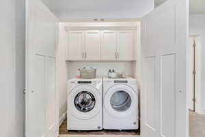 Laundry room with cabinets and washer and dryer