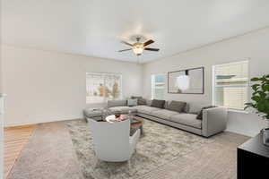 Living room with light hardwood / wood-style floors and ceiling fan