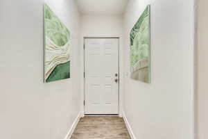 Doorway featuring light wood-type flooring