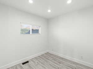 Unfurnished room with light hardwood / wood-style floors