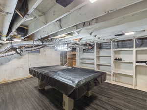 Playroom with dark hardwood / wood-style flooring and pool table