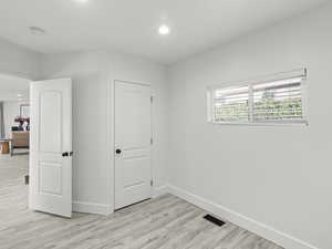 Unfurnished bedroom with light hardwood / wood-style floors