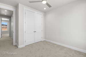 Unfurnished bedroom featuring carpet, a closet, baseboards, and recessed lighting