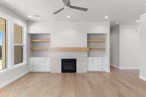 Unfurnished living room featuring baseboards, light wood-type flooring, a ceiling fan, a fireplace, and recessed lighting