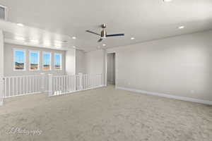 Spare room with recessed lighting, light colored carpet, ceiling fan, and baseboards