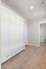 Mudroom with recessed lighting, light wood-style floors, and baseboards