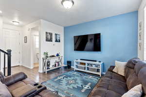 Living room featuring hardwood / wood-style floors and a textured ceiling