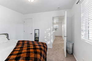 Carpeted bedroom featuring multiple windows