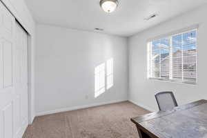 Unfurnished office with carpet and a textured ceiling