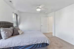 Carpeted bedroom with ceiling fan